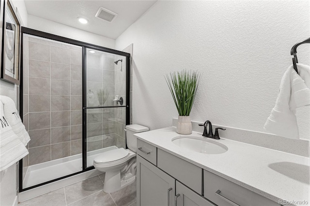 16655 W 93rd Pl, Arvada, CO 80007 - full bathroom featuring a stall shower, tile patterned floors, vanity, and a textured wall