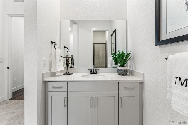 16655 W 93rd Pl, Arvada, CO 80007 - bathroom featuring a textured wall and vanity