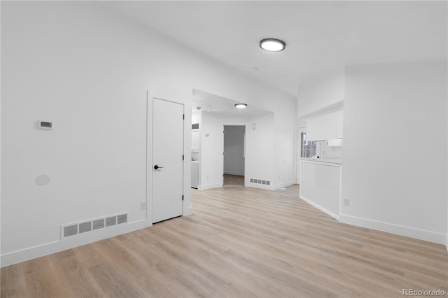 unfurnished room featuring visible vents, light wood-style flooring, and baseboards