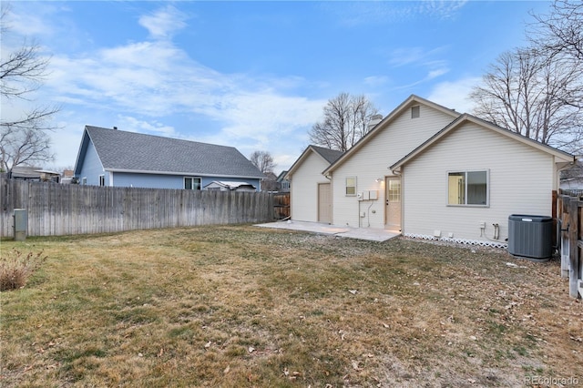 rear view of house featuring cooling unit, a patio area, a lawn, and a fenced backyard