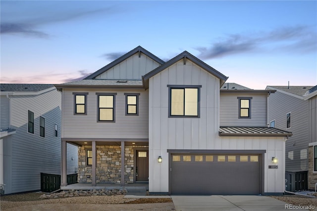 8858 Moonshimmer Trl, Littleton, CO 80125 - modern farmhouse style home with board and batten siding, a porch, driveway, a garage, and a standing seam roof