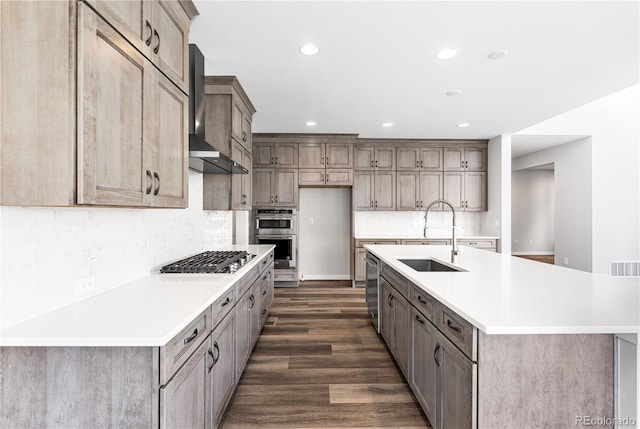 8858 Moonshimmer Trl, Littleton, CO 80125 - kitchen with wall chimney exhaust hood, stainless steel appliances, dark wood finished floors, light countertops, and tasteful backsplash
