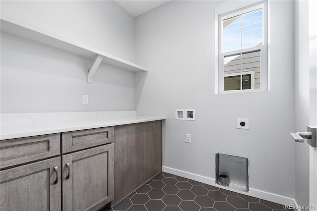 8858 Moonshimmer Trl, Littleton, CO 80125 - washroom featuring hookup for a washing machine, hookup for an electric dryer, cabinet space, and dark tile patterned flooring