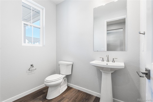8858 Moonshimmer Trl, Littleton, CO 80125 - half bathroom with toilet and wood finished floors