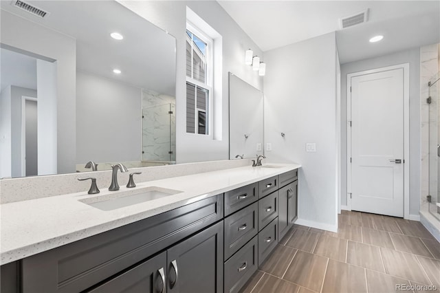 8858 Moonshimmer Trl, Littleton, CO 80125 - full bathroom featuring a marble finish shower, double vanity, and recessed lighting