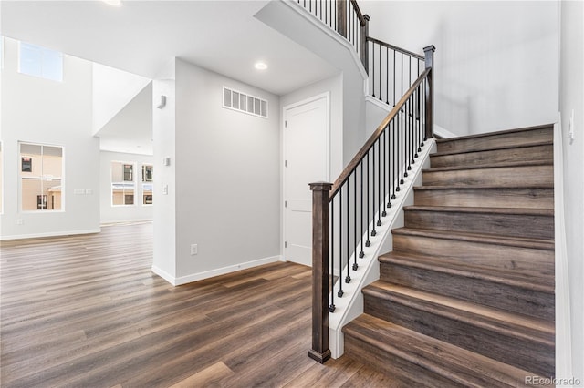 8858 Moonshimmer Trl, Littleton, CO 80125 - stairs featuring wood finished floors, recessed lighting, and a towering ceiling