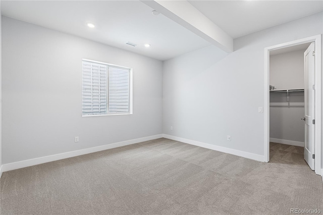 8858 Moonshimmer Trl, Littleton, CO 80125 - unfurnished bedroom featuring carpet floors, a walk in closet, recessed lighting, and beam ceiling