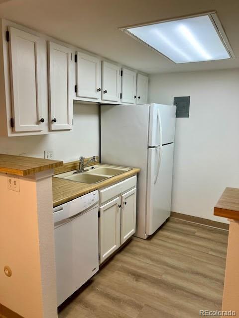 4400 S Quebec St Unit 102R, Denver, CO 80237 - kitchen with white dishwasher, a sink, light wood finished floors, and white cabinetry