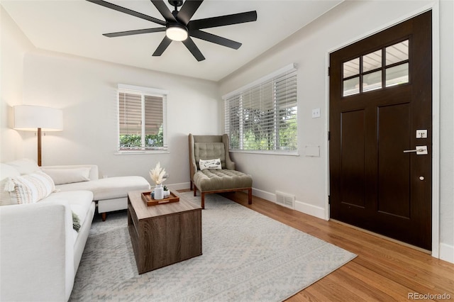4520 S Delaware St, Englewood, CO 80110 - living area with healthy amount of natural light, light wood finished floors, baseboards, and ceiling fan