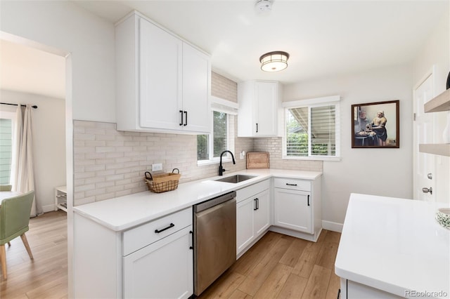 4520 S Delaware St, Englewood, CO 80110 - kitchen featuring dishwasher, a sink, backsplash, light wood-style flooring, and light countertops