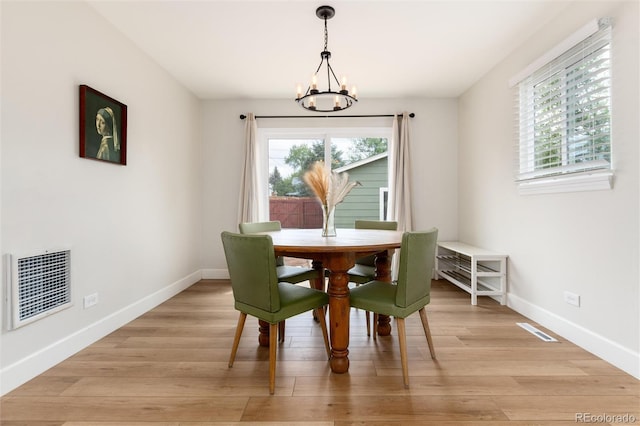 4520 S Delaware St, Englewood, CO 80110 - dining area featuring a chandelier, baseboards, and light wood-style floors