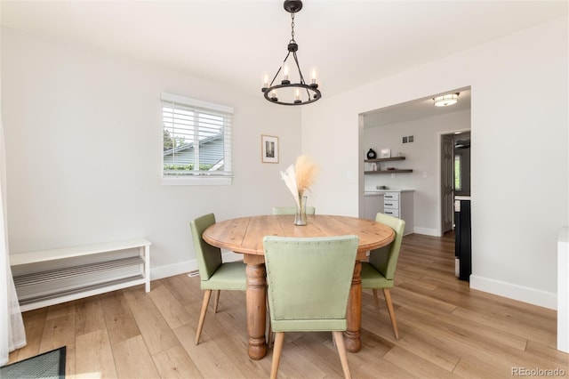 4520 S Delaware St, Englewood, CO 80110 - dining space featuring a chandelier, baseboards, and light wood finished floors