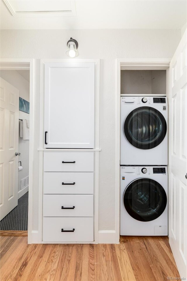 4520 S Delaware St, Englewood, CO 80110 - laundry room with stacked washer / drying machine and light wood-type flooring