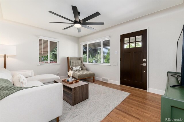 4520 S Delaware St, Englewood, CO 80110 - living area with a ceiling fan, light wood finished floors, and baseboards