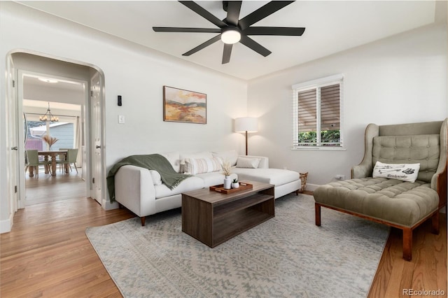 4520 S Delaware St, Englewood, CO 80110 - living area with ceiling fan, light wood-type flooring, a chandelier, and plenty of natural light