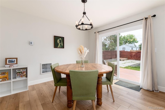 4520 S Delaware St, Englewood, CO 80110 - dining space with a chandelier, light wood-style flooring, and baseboards