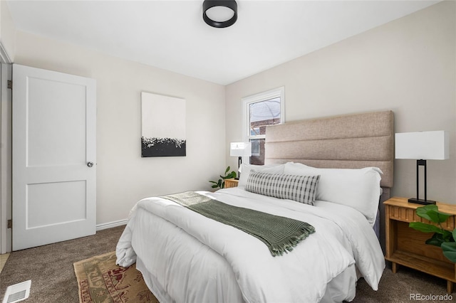 bedroom featuring dark colored carpet