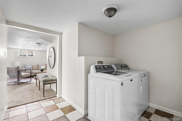 laundry room with separate washer and dryer and light tile patterned floors