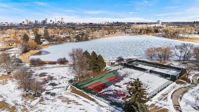 snowy aerial view with a water view