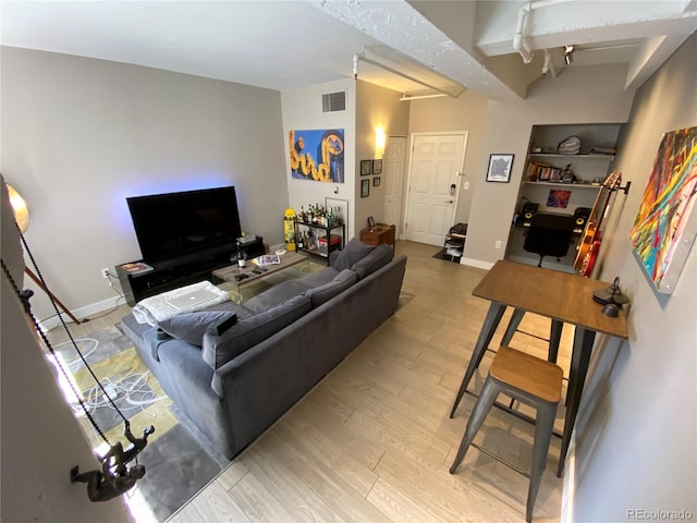 444 17th St Unit 508, Denver, CO 80202 - living room featuring wood finished floors and beamed ceiling