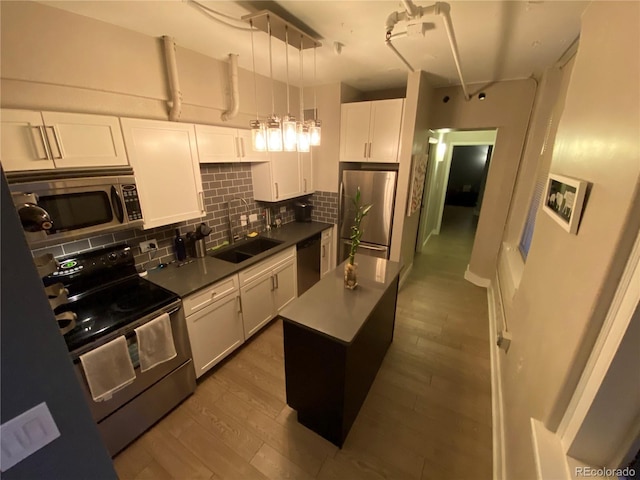 444 17th St Unit 508, Denver, CO 80202 - kitchen with stainless steel appliances, backsplash, white cabinetry, dark countertops, and dark wood finished floors