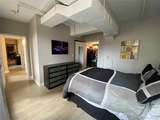 444 17th St Unit 508, Denver, CO 80202 - bedroom featuring light wood-style flooring, a closet, and a walk in closet