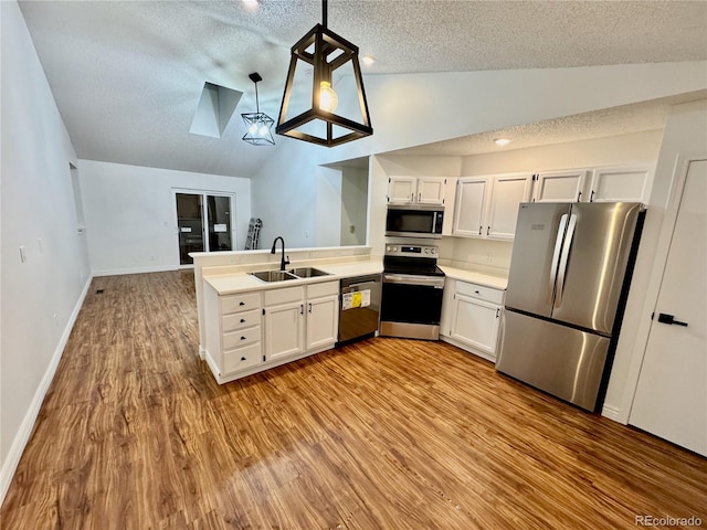 4036 S Himalaya Cir, Aurora, CO 80013 - kitchen with stainless steel appliances, a sink, lofted ceiling, a textured ceiling, and light wood-style floors