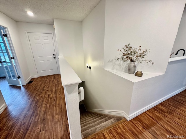 4036 S Himalaya Cir, Aurora, CO 80013 - stairway featuring wood finished floors, baseboards, and a textured ceiling