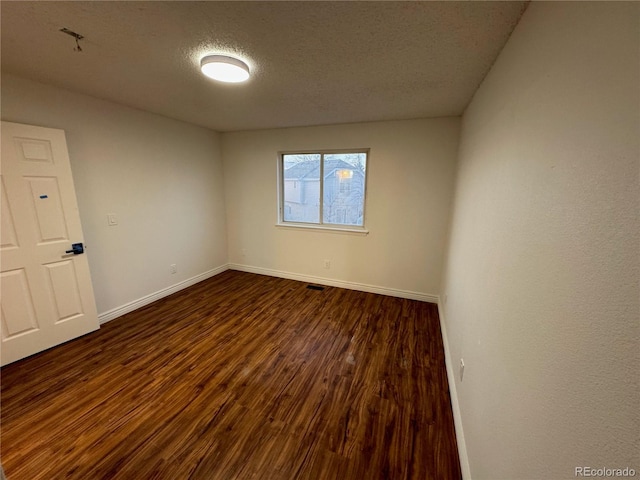 4036 S Himalaya Cir, Aurora, CO 80013 - empty room with dark wood-style floors, baseboards, and a textured ceiling