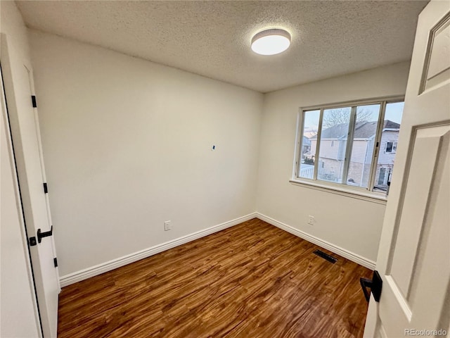 4036 S Himalaya Cir, Aurora, CO 80013 - empty room with a textured ceiling, wood finished floors, and baseboards