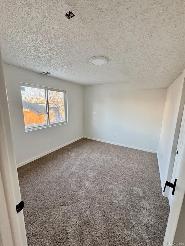 4036 S Himalaya Cir, Aurora, CO 80013 - empty room featuring carpet floors, baseboards, and a textured ceiling