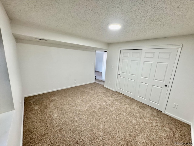4036 S Himalaya Cir, Aurora, CO 80013 - unfurnished bedroom with a textured ceiling, carpet, a closet, and baseboards