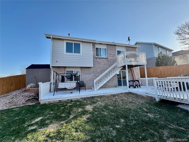 4036 S Himalaya Cir, Aurora, CO 80013 - rear view of house featuring a wooden deck, stairway, brick siding, and a patio