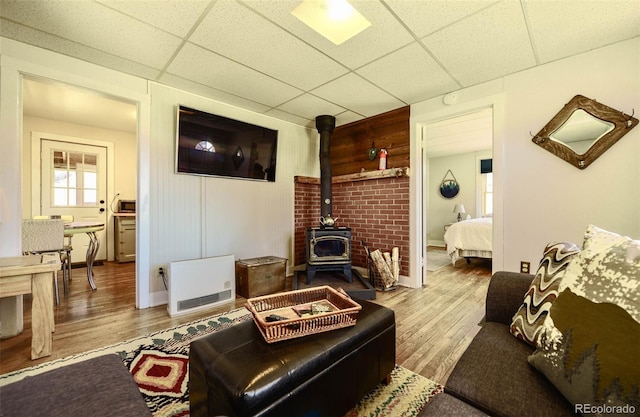 140 Eighth St, Fairplay, CO 80440 - living area with a paneled ceiling, a wood stove, wood finished floors, and baseboards