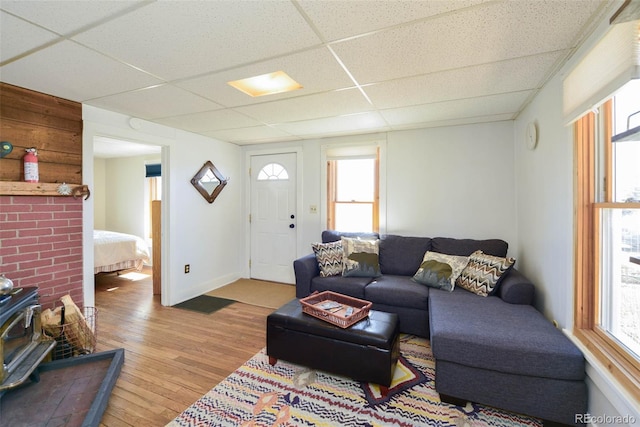 140 Eighth St, Fairplay, CO 80440 - living area featuring a paneled ceiling, a wood stove, wood finished floors, and baseboards
