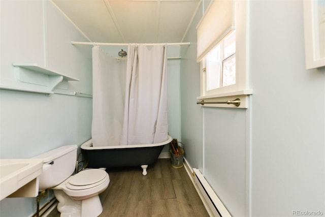 140 Eighth St, Fairplay, CO 80440 - full bathroom featuring a baseboard heating unit, wood finished floors, toilet, and shower / tub combo with curtain