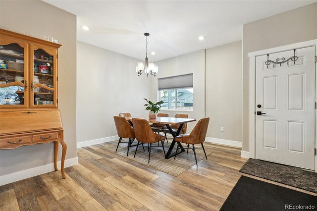 3165 W 63rd Ave, Denver, CO 80221 - dining room with light wood-style flooring, an inviting chandelier, baseboards, and recessed lighting