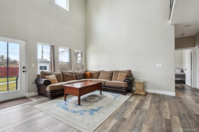3165 W 63rd Ave, Denver, CO 80221 - living area with a towering ceiling, baseboards, and wood finished floors