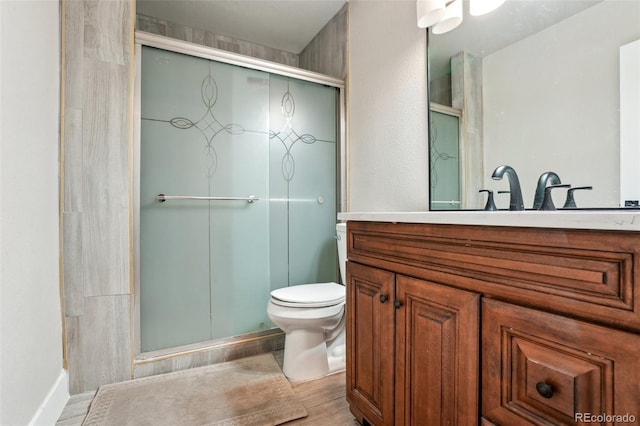 3165 W 63rd Ave, Denver, CO 80221 - bathroom featuring toilet, a stall shower, wood finished floors, and vanity