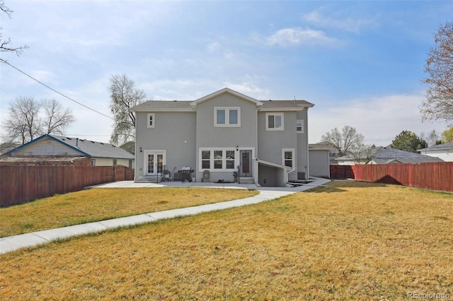 3165 W 63rd Ave, Denver, CO 80221 - rear view of house with french doors, a fenced backyard, stucco siding, and a yard
