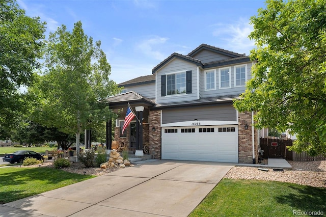 16086 E 97th Pl, Commerce City, CO 80022 - view of front of property with a garage, driveway, brick siding, and a tiled roof