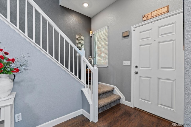 16086 E 97th Pl, Commerce City, CO 80022 - entrance foyer with dark wood-style flooring, stairs, and a textured wall