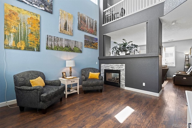 16086 E 97th Pl, Commerce City, CO 80022 - living area featuring wood finished floors and a stone fireplace