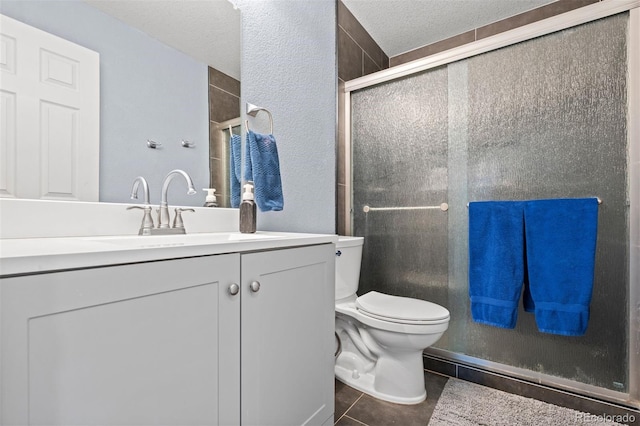 16086 E 97th Pl, Commerce City, CO 80022 - full bath with a shower with shower door, tile patterned flooring, vanity, and a textured ceiling
