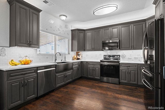 16086 E 97th Pl, Commerce City, CO 80022 - kitchen featuring stainless steel appliances, backsplash, dark wood finished floors, and light countertops