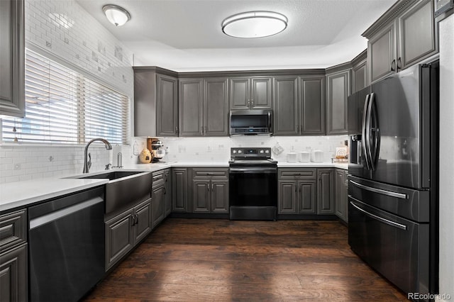 16086 E 97th Pl, Commerce City, CO 80022 - kitchen with appliances with stainless steel finishes, tasteful backsplash, light countertops, and dark wood finished floors