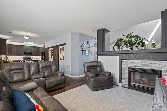 16086 E 97th Pl, Commerce City, CO 80022 - living area featuring wood finished floors and a fireplace