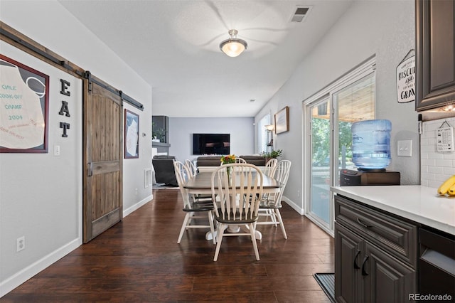 16086 E 97th Pl, Commerce City, CO 80022 - dining area featuring a barn door and dark wood-type flooring