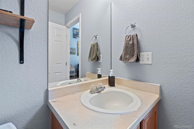 16086 E 97th Pl, Commerce City, CO 80022 - bathroom featuring vanity and a textured wall