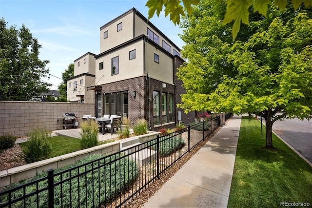 3690 W Byron Pl, Denver, CO 80211 - view of property exterior featuring stucco siding, brick siding, and a patio